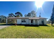 Charming single story home featuring a carport and a well-maintained front yard at 6012 Landover Blvd, Spring Hill, FL 34609