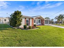 Charming single-story home boasts a well-manicured lawn and inviting front porch perfect for relaxing at 6536 Beach Blvd, Hudson, FL 34667