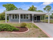 Charming single-story home with a well-maintained lawn and a covered front entrance, perfect for enjoying the outdoors at 7506 Moriah Ave, Brooksville, FL 34613