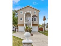 Charming home with two-car garage, a landscaped yard, and inviting front entrance at 856 Wisconsin Ave, Palm Harbor, FL 34683