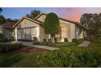 Charming single-story home featuring a well-manicured lawn, tidy landscaping, and an attached two-car garage at 1005 Indigo Run Ct, Spring Hill, FL 34609