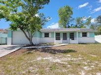 Charming single-story home featuring a well-maintained yard and a brick and siding facade at 10921 Stamford Dr, Port Richey, FL 34668