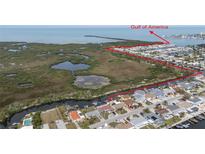 Stunning aerial view of waterfront homes, canals, and the Gulf of Mexico in a desirable coastal community at 12801 5Th Isle, Hudson, FL 34667