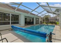Enclosed pool with cover, screened patio, and lush backyard landscaping for private outdoor living at 2309 Terrace View Ln, Spring Hill, FL 34606
