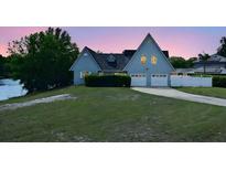 Charming home featuring a neatly manicured lawn, symmetrical roof lines, and attached two car garage at 23310 Cascade Pl, Land O Lakes, FL 34639
