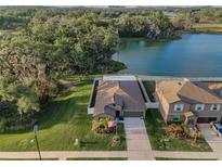 Stunning aerial view of home with lake and lush landscaping providing a serene and private setting at 36419 Flats St, Zephyrhills, FL 33541