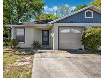 Charming single-story home featuring a front yard and attached garage on a sunny day at 3741 Appleton Ct, Palm Harbor, FL 34684
