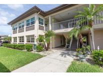Condo exterior with mature landscaping, walkway, stairs and second floor balcony at 4557 Garnet Dr # 102, New Port Richey, FL 34652