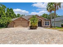 Charming single-Gathering home with a spacious driveway and well-maintained landscaping, including palm trees at 7925 Calindra Ct, Trinity, FL 34655