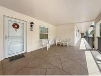 Inviting condo hallway with neutral tones and charming outdoor seating at 861 Maple Ct # 205, Dunedin, FL 34698