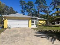 Charming single-Gathering home featuring a one car garage and mature landscaping at 1332 Inca Ave, Spring Hill, FL 34608