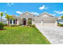 Charming single-story home with lush landscaping, a well-manicured lawn, and a two-car garage at 15912 42Nd E Gln, Parrish, FL 34219