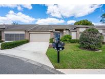Charming home with a well-maintained front yard and a two-car garage at 3160 Whispering Pines Ct, Spring Hill, FL 34606