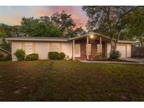 Charming single-story home featuring a brick accent wall and a well-maintained front lawn at 4559 Crescent Rd, Spring Hill, FL 34606