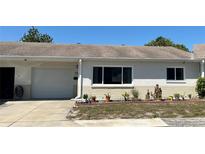Charming single-story home features a well-maintained front yard, attached garage, and a neutral stucco exterior at 4653 Cambridge Ave # 4653, New Port Richey, FL 34652