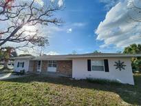Charming single-story home with a brick accent, manicured lawn, and mature tree at 6819 Treehaven Dr, Spring Hill, FL 34606