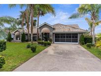 Charming home with mature landscaping, neutral paint, and a tile roof at 8200 Rhanbuoy Rd, Spring Hill, FL 34606