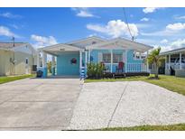 Charming coastal-style home with a front porch and a spacious driveway, perfect for relaxing at 4400 Floramar Ter, New Port Richey, FL 34652