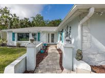 Charming single-story home featuring a stone exterior and a welcoming brick walkway leading to the front door at 4573 Ontario Dr, New Port Richey, FL 34652