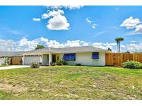 Charming single-story home with a well-maintained lawn, mature landscaping, and a welcoming entrance at 4731 Egret Rd, Venice, FL 34293