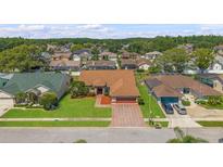 Well-maintained home with brick driveway and manicured lawn in a desirable neighborhood at 5411 Wellfield Rd, New Port Richey, FL 34655