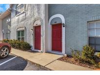 Charming townhome entrance with brick facade, arched doorways, and well-maintained landscaping at 5651 Townhouse Dr # 5651, New Port Richey, FL 34652