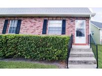 Charming brick home featuring a well-maintained front entrance with black shutters and manicured landscaping at 6710 Hickorywood Ln # 1B, New Port Richey, FL 34653
