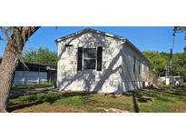 Charming single-story home with white siding and black shutters, nestled in a lush green lawn at 11304 Altoona Ave, New Port Richey, FL 34654