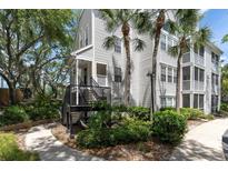 Attractive condo exterior with palm trees and manicured landscaping, walkable to a community at 3260 Haviland Ct # 201, Palm Harbor, FL 34684