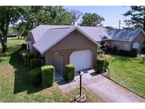 Charming single-story home featuring a well-maintained lawn, trimmed hedges, and attached one car garage at 4836 Alamo Ct, New Port Richey, FL 34655