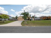Charming single-story home featuring a well-maintained lawn, long driveway, and a welcoming facade at 5092 Roble Ave, Spring Hill, FL 34608