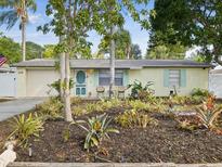 Charming one-story home with colorful landscaping, pastel exterior and matching trim at 6329 Alaska Ave, New Port Richey, FL 34653