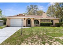 Charming single-story home with well-maintained landscaping, stone accents, and a two-car garage at 8466 Eldridge Rd, Spring Hill, FL 34608