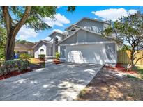 Charming two-story home featuring a two-car garage, well-maintained landscaping, and a welcoming driveway at 10423 Ashley Oaks Dr, Riverview, FL 33578