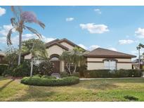 Charming single-story home with well-manicured landscaping, mature palms, and inviting curb appeal at 1641 Bayfield Ct, Trinity, FL 34655