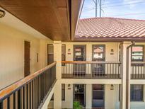 Exterior view of a building with balconies, offering a charming residential experience at 2410 Hammock Pine Blvd # 2410, Clearwater, FL 33761