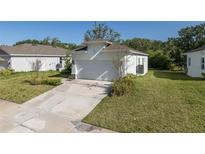 Charming single-story home with a well-manicured lawn and a two car garage at 4082 Watson Dr, New Port Richey, FL 34655