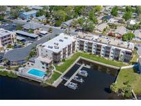 Aerial view of the Rivermist Condominiums with waterfront access, boat docks, and community pool at 5640 Ferguson Ct # 2106, New Port Richey, FL 34652