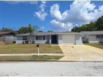 Charming single-story home with a well-maintained lawn and attached one car garage at 5651 Canosa Dr, Holiday, FL 34690
