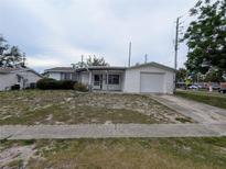 Charming single-story home with attached garage and a covered front porch at 5949 1St Ave, New Port Richey, FL 34652