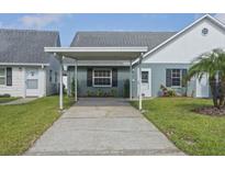 Charming single-story home featuring a covered parking area and well-maintained landscaping at 6047 Elmhurst Dr # 5A, New Port Richey, FL 34653