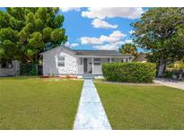 Charming single-story home featuring a well-manicured lawn and inviting walkway at 4035 Fairfield S Ave, St Petersburg, FL 33711