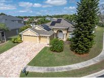 Lovely single-story home featuring a well-manicured lawn, solar panels, and a two-car garage at 6109 Japonica Ct, New Port Richey, FL 34655