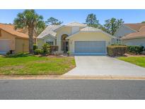 Charming single-story home with a well-manicured front yard, mature landscaping, and a two-car garage at 9398 Mississippi Run, Weeki Wachee, FL 34613