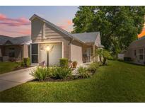 Charming home with manicured lawn, cozy front porch, and attached garage at 4856 Alamo Ct # 4856, New Port Richey, FL 34655