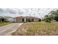 Charming single-story home with a two-car garage and manicured lawn at 1034 Aladdin Rd, Spring Hill, FL 34609