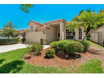 Charming home features a red tile roof and lush landscaping at 1171 Dartford Dr, Tarpon Springs, FL 34688