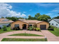 Charming one-story home with landscaped front yard and inviting curb appeal with attached garage at 13111 Sheridan Dr, Hudson, FL 34667