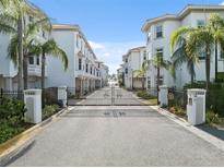 Elegant gated community entrance with palm trees and well-maintained landscaping at 1340 Bayshore Blvd # 411, Dunedin, FL 34698