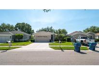 Charming single-story home with well-manicured lawn and inviting curb appeal in a quiet neighborhood at 15038 Tamarind Loop, Spring Hill, FL 34609